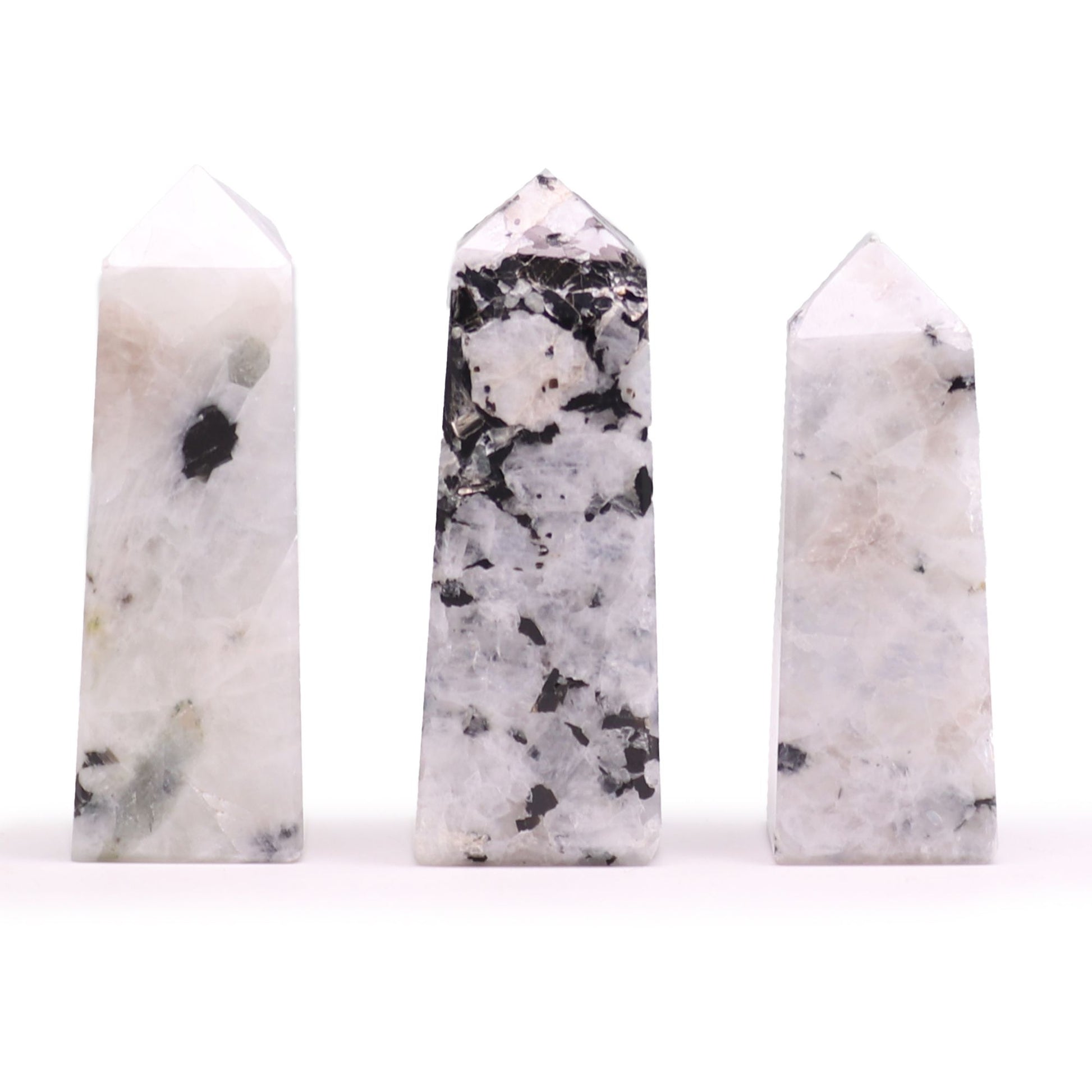 A smooth, polished moonstone obelisk point standing upright, showing natural iridescent gemstone textures.