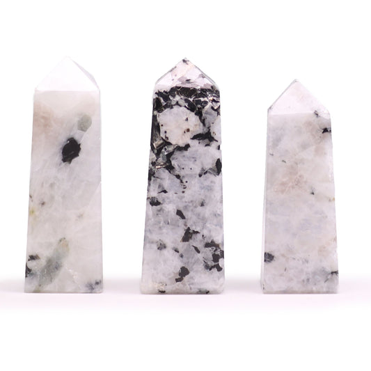 A smooth, polished moonstone obelisk point standing upright, showing natural iridescent gemstone textures.