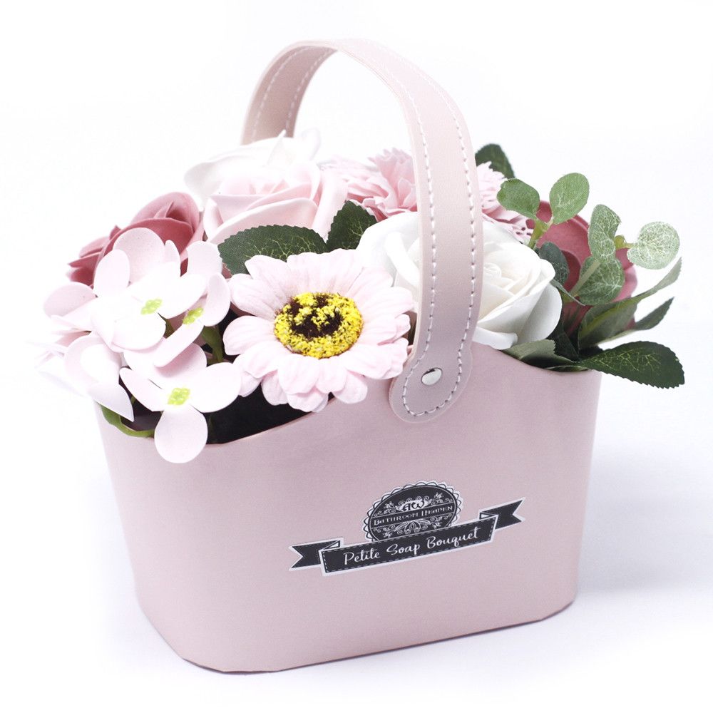 Artistically arranged pink soap roses in a petite wicker basket, designed for a luxurious and fragrant bath experience.