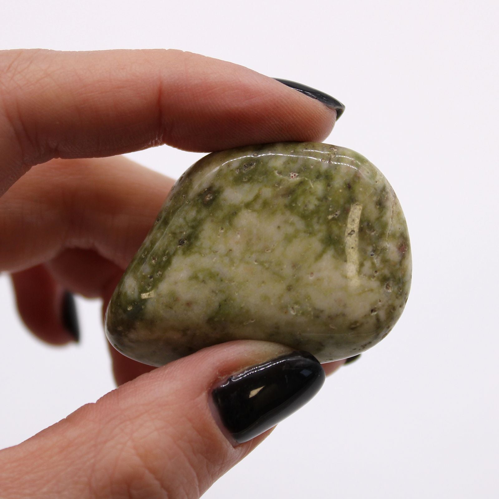 Large polished khaki green tumble stone with white quartz snowflake-like patterns.