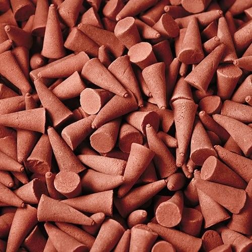 Large pile of golden-brown incense cones with a slightly textured surface, suitable for spiritual and home fragrance use.