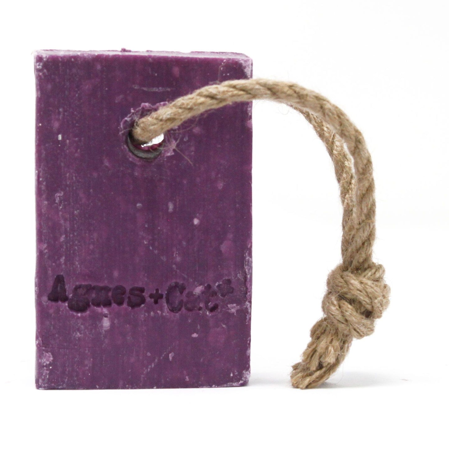 Pink floral-scented soap on a natural rope hanging against a minimalist background.