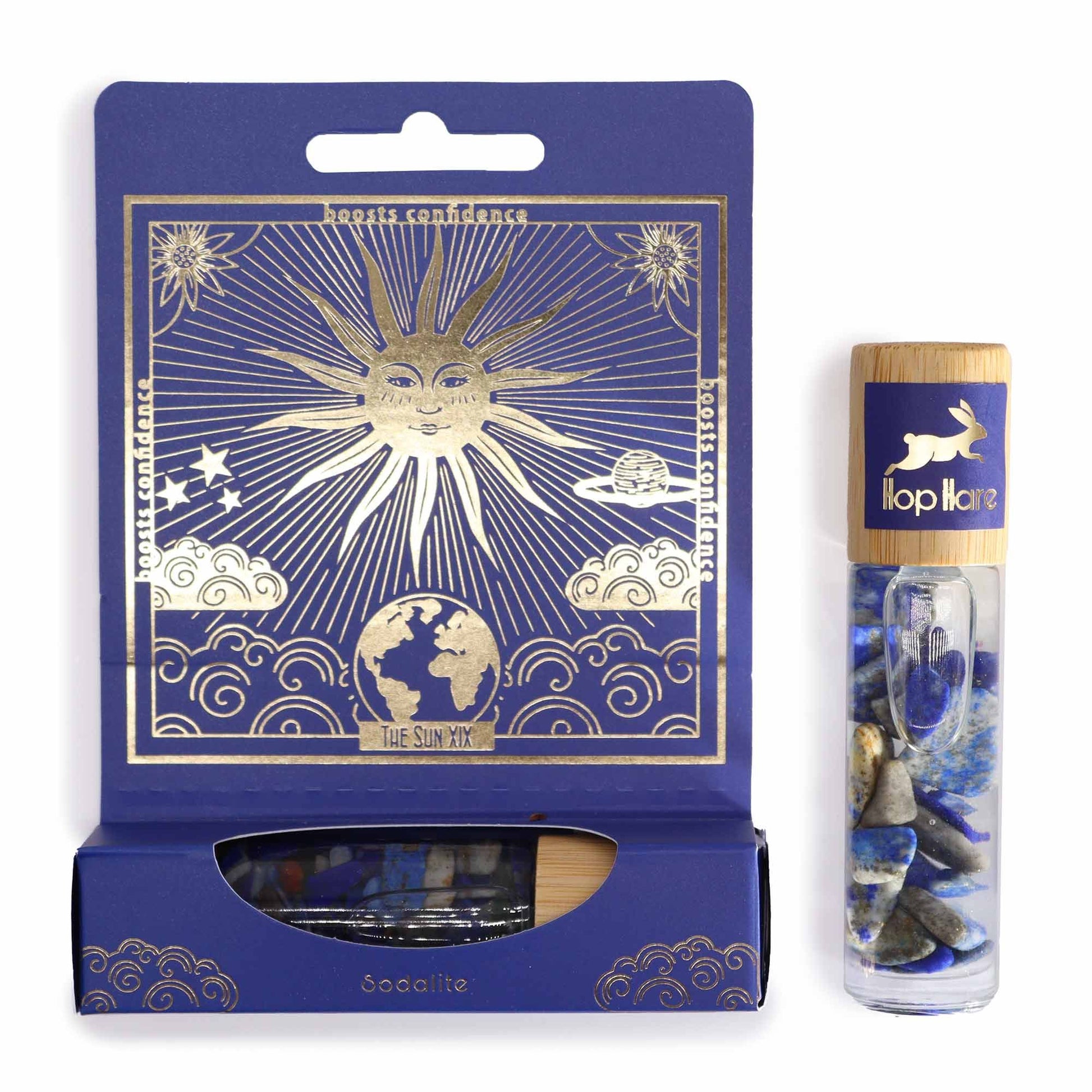 Amber glass roller bottle with a sun-themed tarot card label and blue Sodalite gemstones inside.