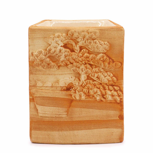 Intricately hand-painted ceramic oil burner with a bonsai tree motif and a textured sand-coloured finish.