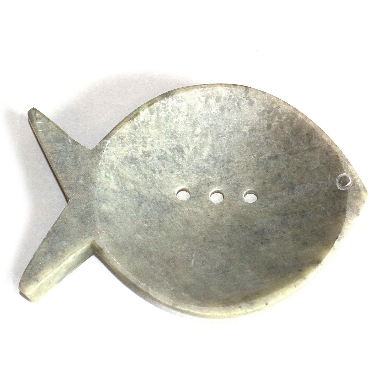 Hand-carved natural soapstone soap dish shaped like a fish with three drainage holes on a neutral background.