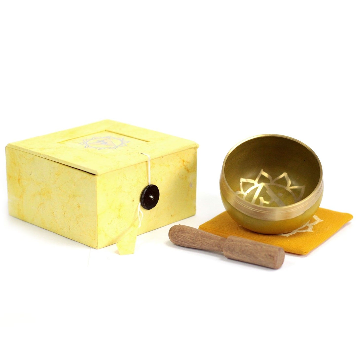 Handcrafted yellow chakra singing bowl with a wooden striker on a neutral background.