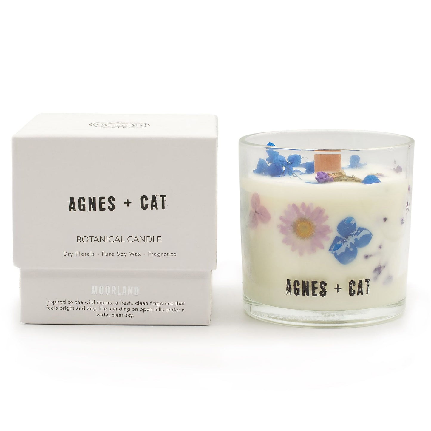 Elegant botanical soy wax candle featuring embedded dried florals and a fresh moorland scent.