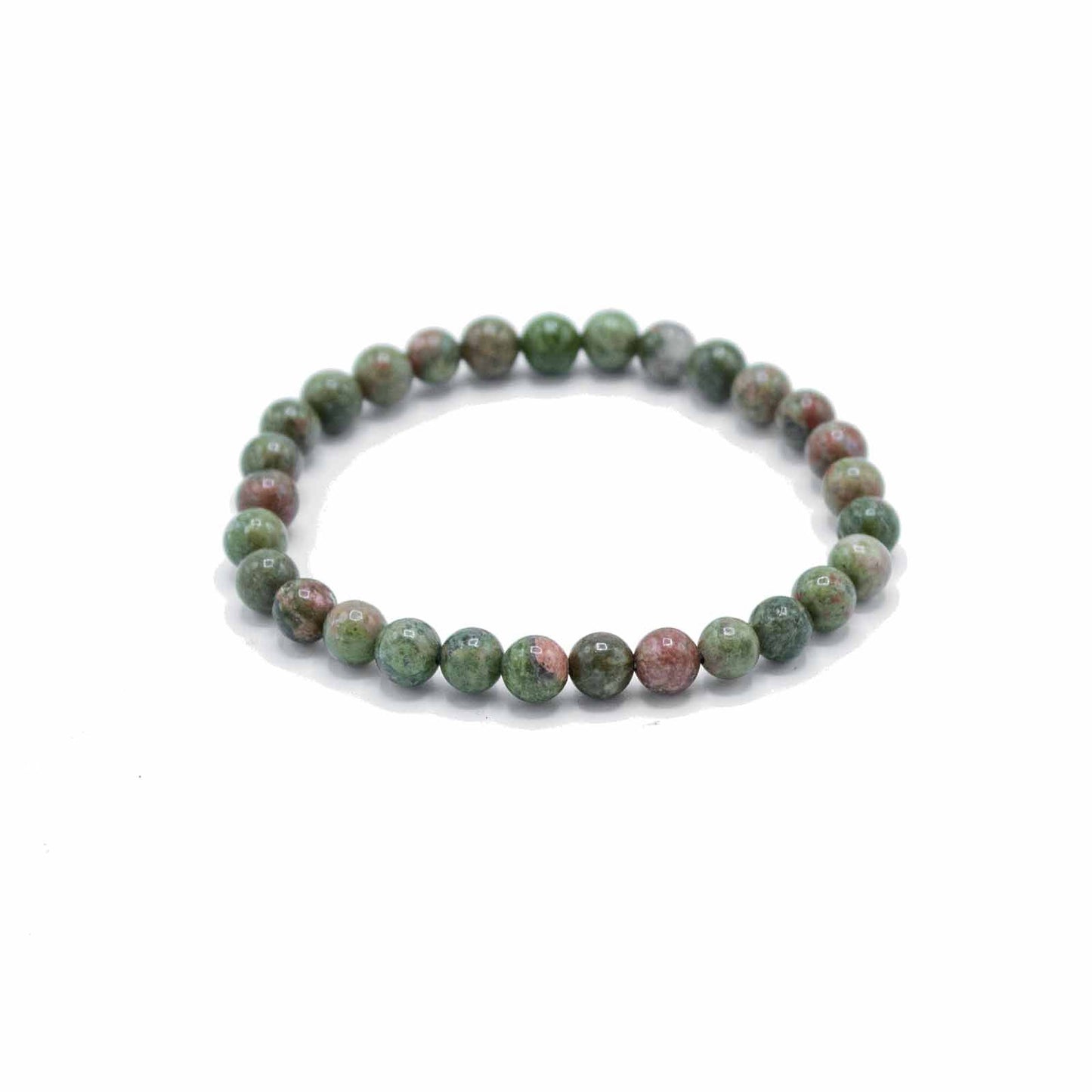 Close-up of a spiritual manifestation bracelet featuring smooth, earthy green jasper gemstone beads on an elastic cord.