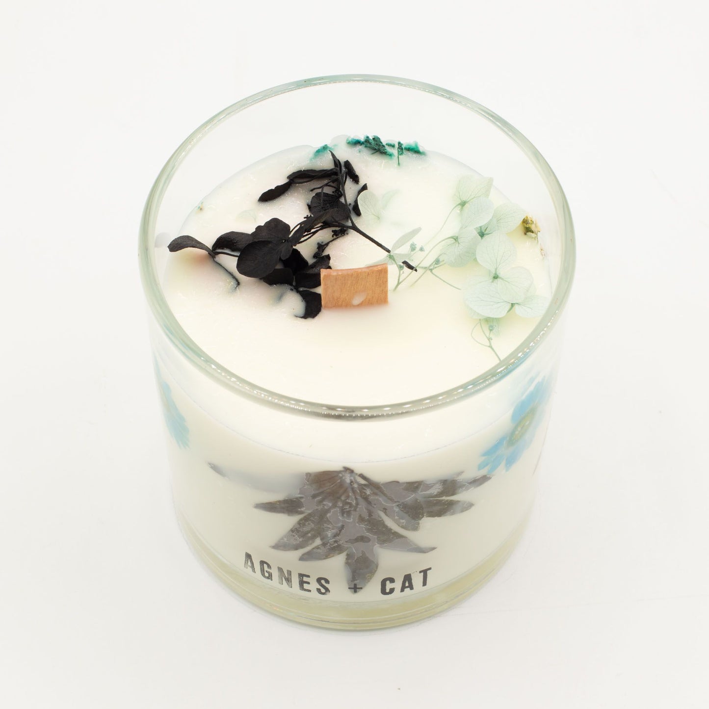 Hand-poured botanical soy wax candle featuring dried moss and petals, emitting a fresh sea salt and earthy fragrance.