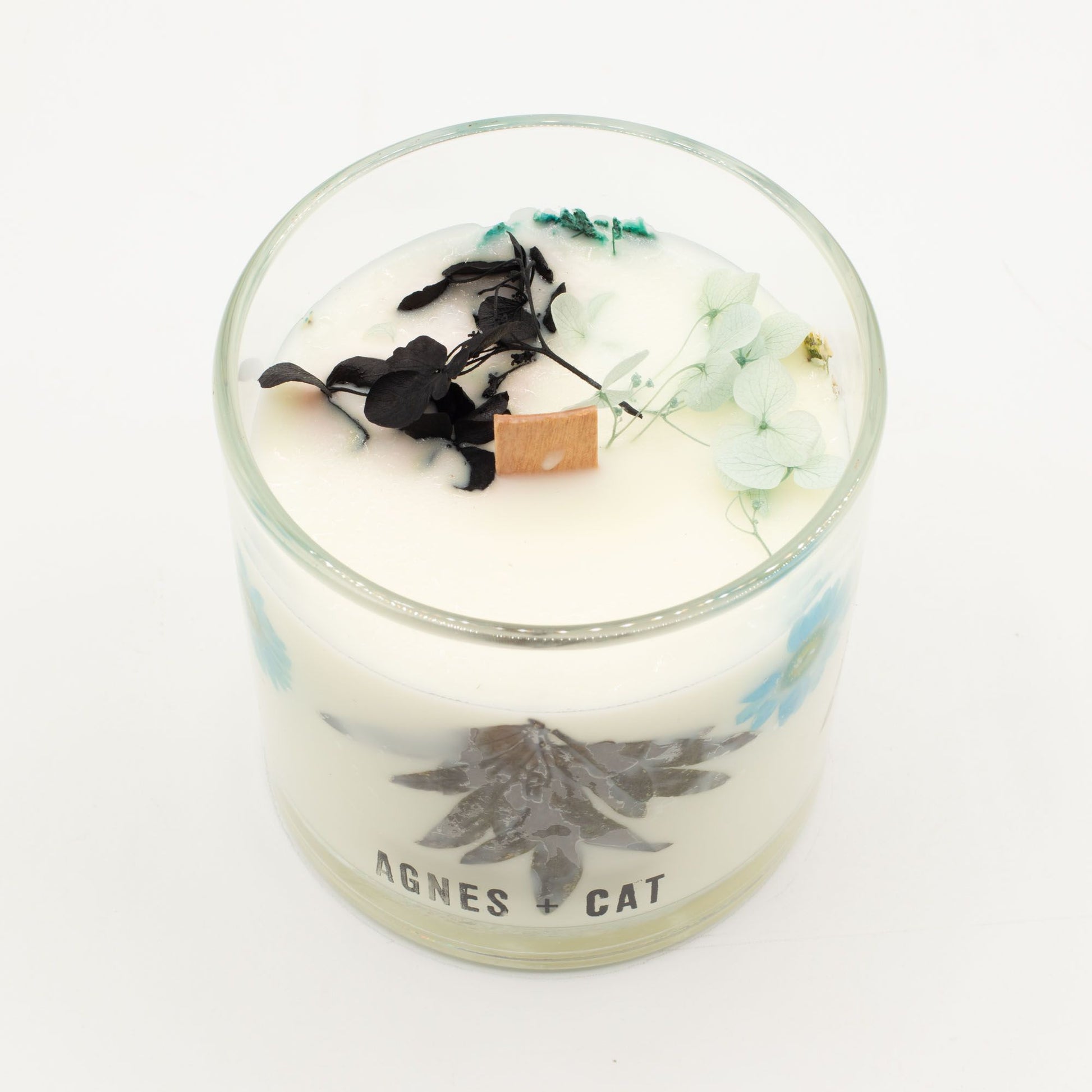 Hand-poured botanical soy wax candle featuring dried moss and petals, emitting a fresh sea salt and earthy fragrance.