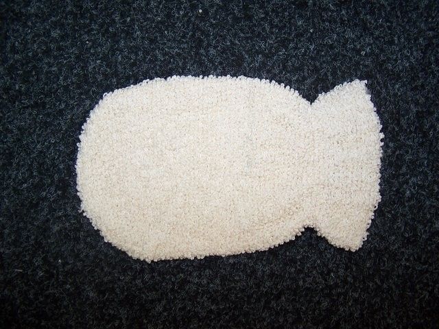 Soft cream-coloured bamboo washing mitt with a textured weave for gentle skin exfoliation.