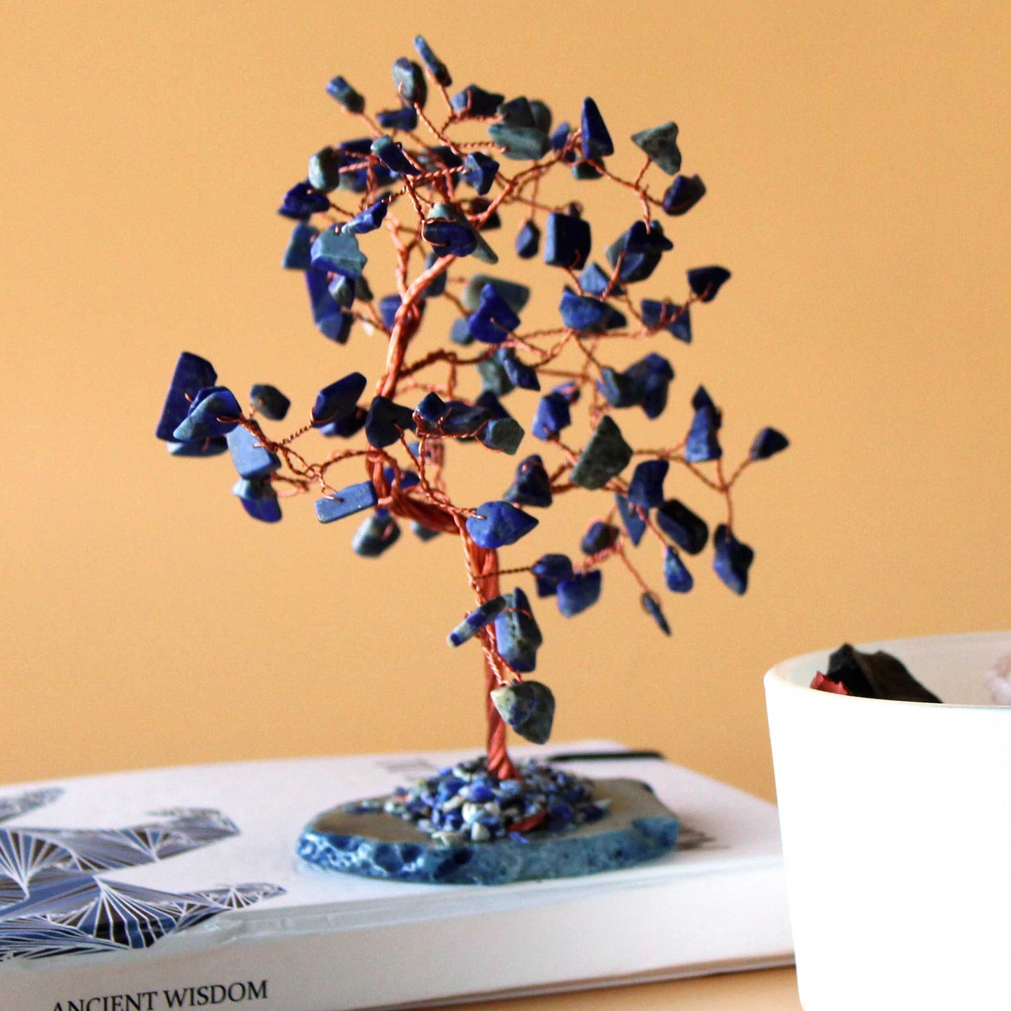 Large gemstone tree with blue sodalite stones on a vibrant blue agate base with copper wire branches.