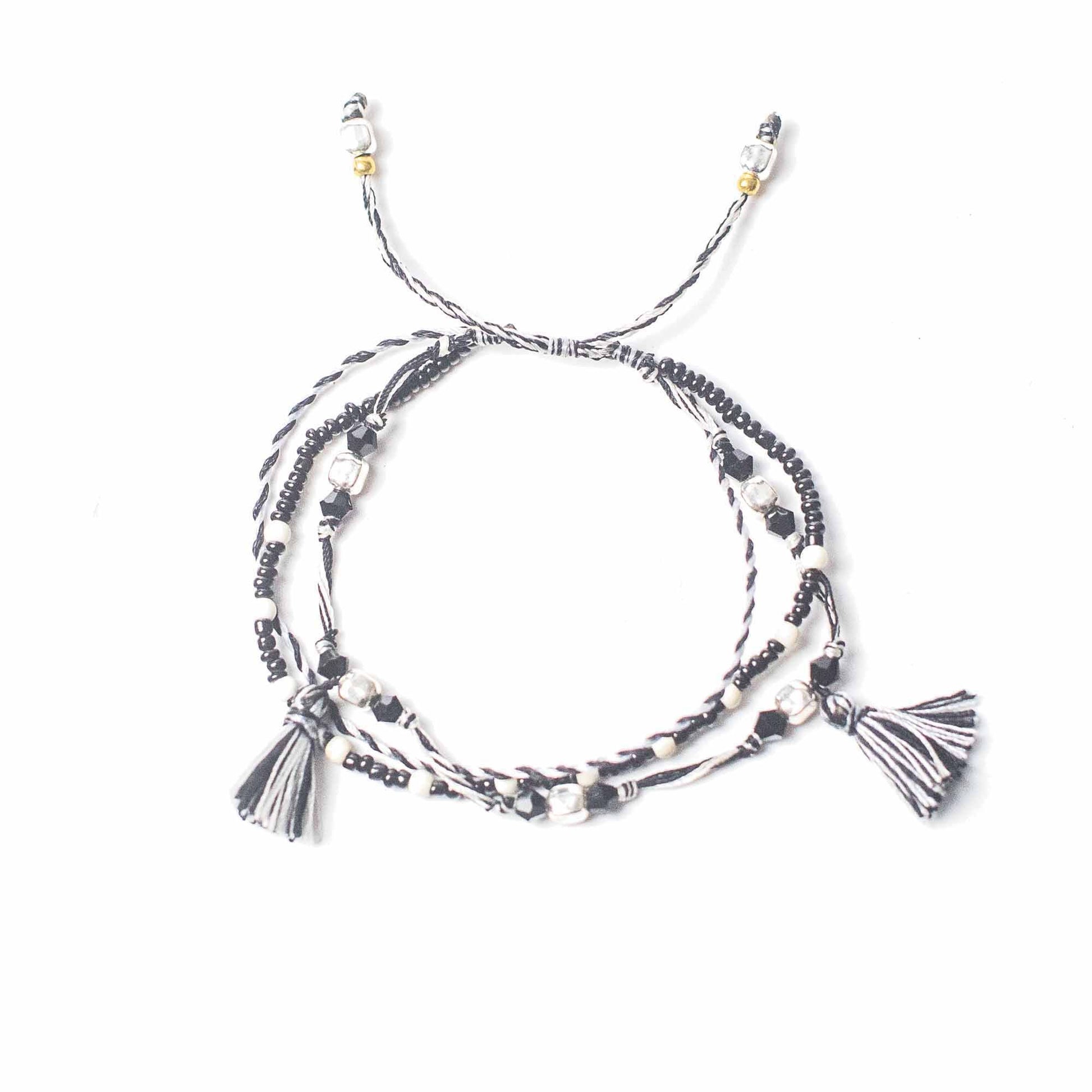 Handcrafted black string bracelet featuring small silver beads and a minimalist adjustable design.