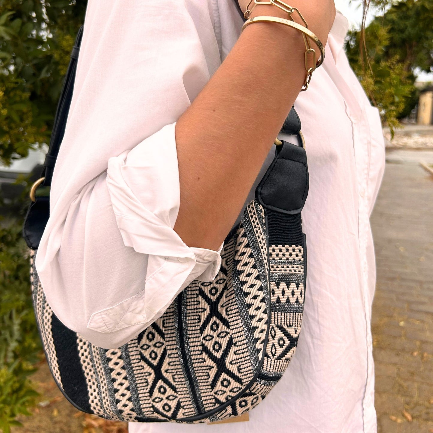 Stylish grey jacquard hobo bag with an intricate geometric pattern and a durable black shoulder strap.
