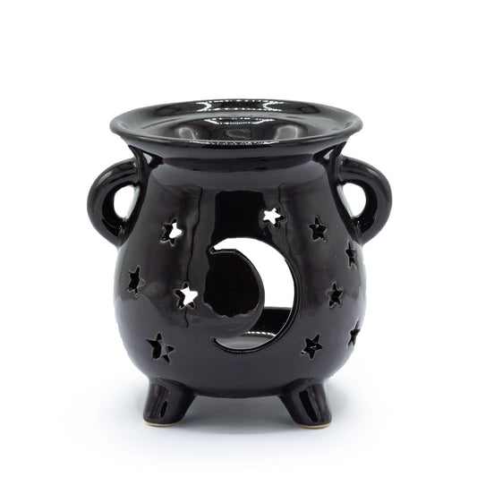Black ceramic cauldron-shaped oil burner with carved moon and star patterns and a sturdy three-legged base.