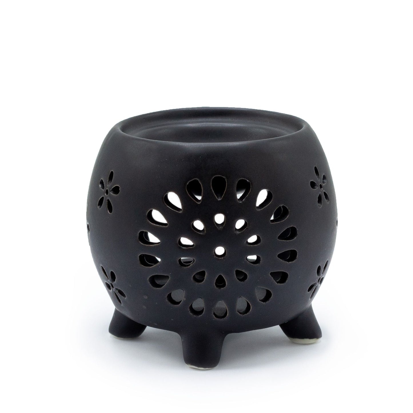 Squat matt black ceramic oil burner featuring a decorative flower burst cutout pattern.