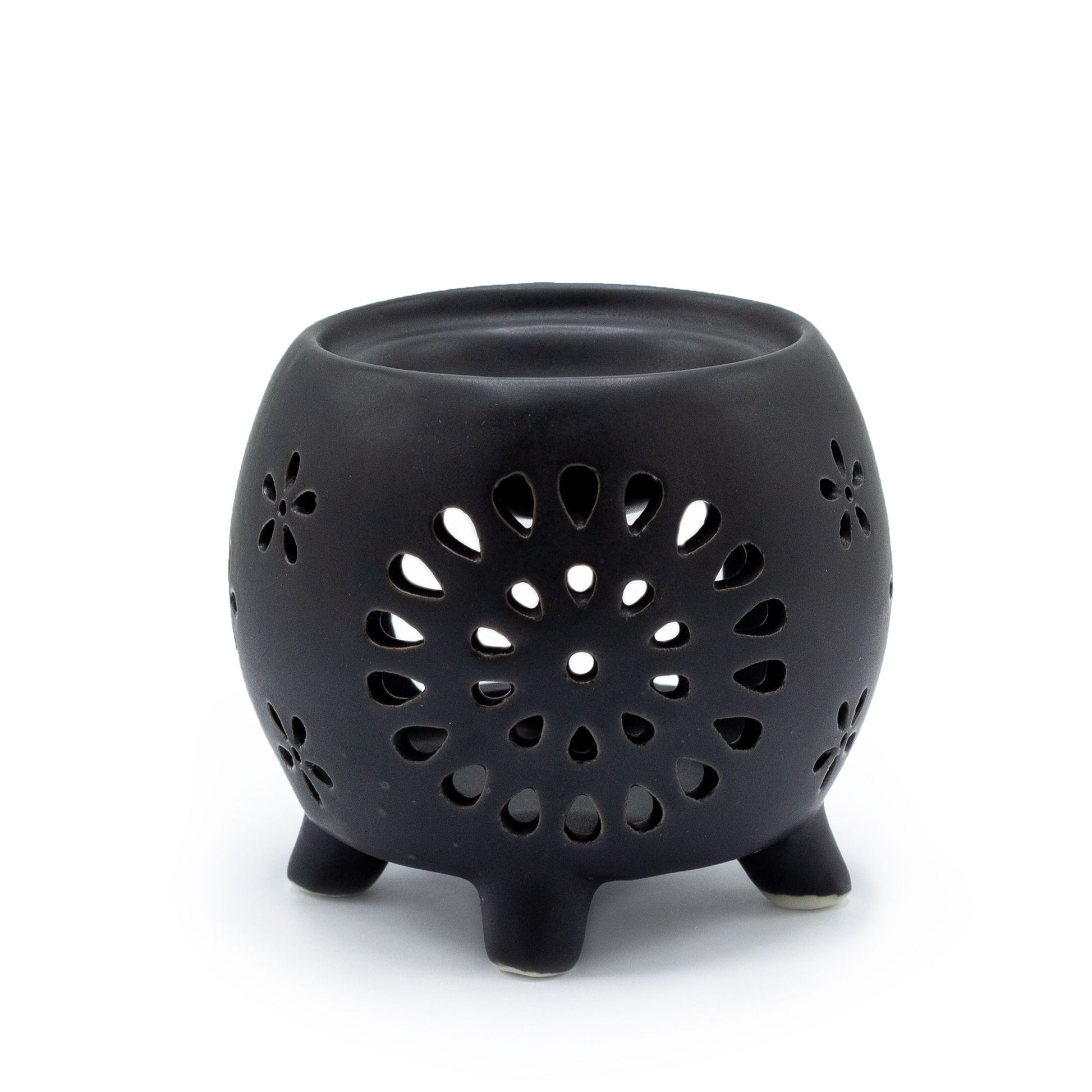 Squat matt black ceramic oil burner featuring a decorative flower burst cutout pattern.