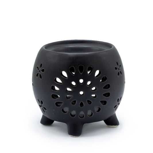 Squat matt black ceramic oil burner featuring a decorative flower burst cutout pattern.