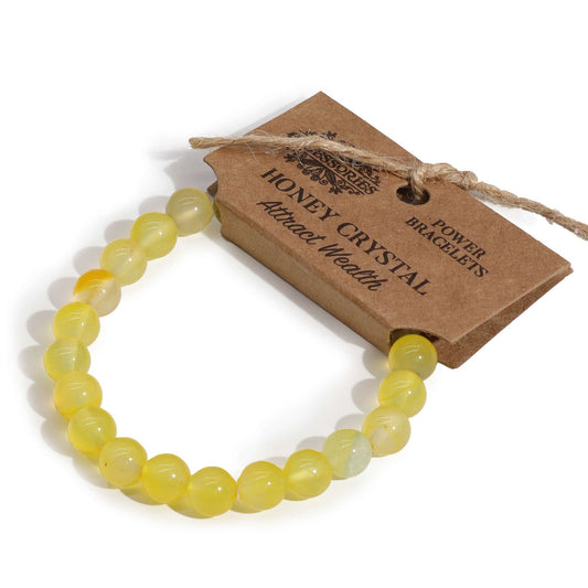 Handcrafted power bracelet featuring smooth, translucent honey-coloured crystal beads on an elasticated cord.