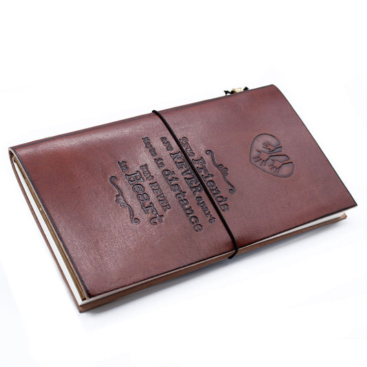 Slim brown leather journal featuring an embossed quote and decorative wrap-around band closure.