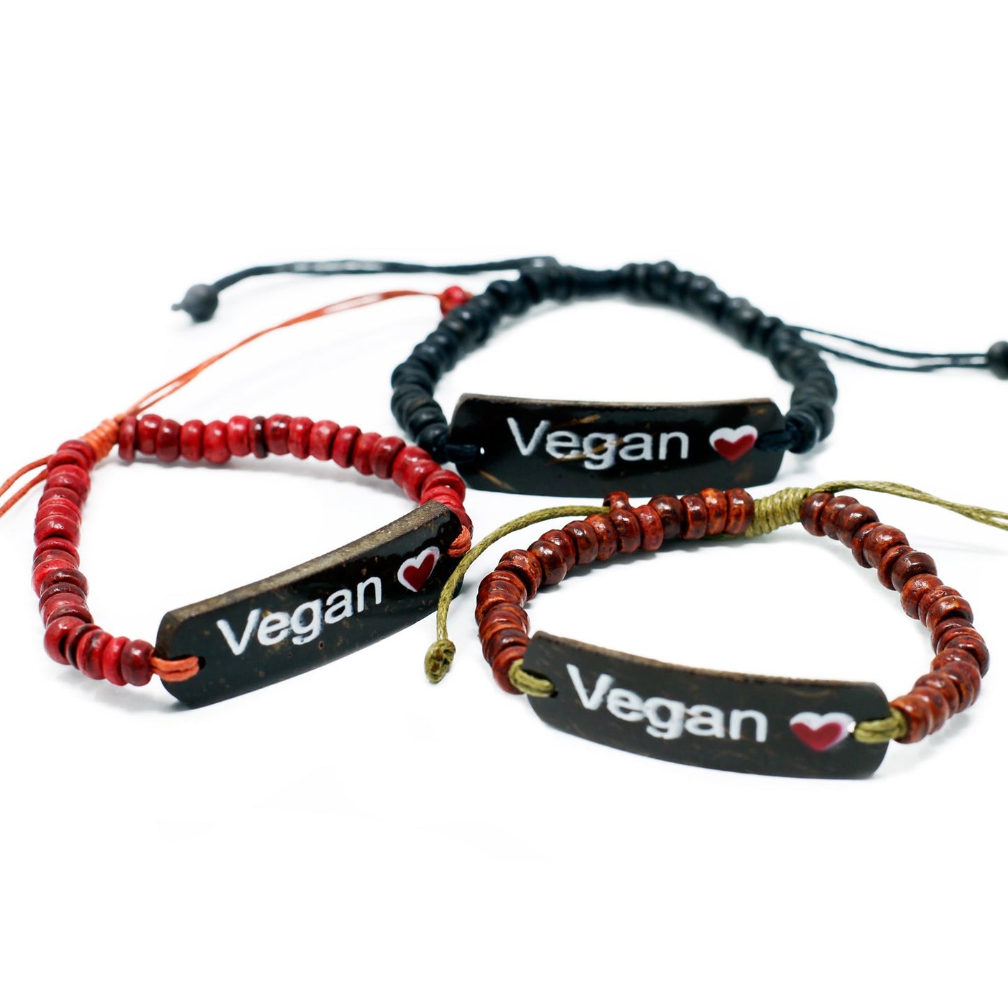 Handcrafted stretch bracelet made of dark coconut wood beads featuring a white bead with the word Vegan and a small heart.