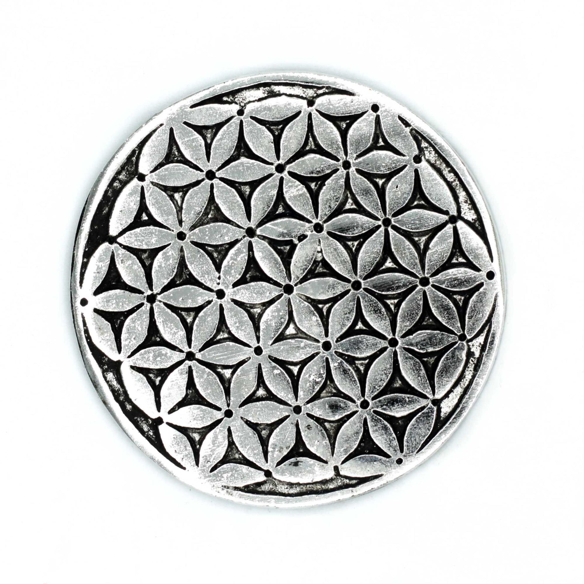Round polished aluminium incense holder featuring an etched Flower of Life geometric pattern.