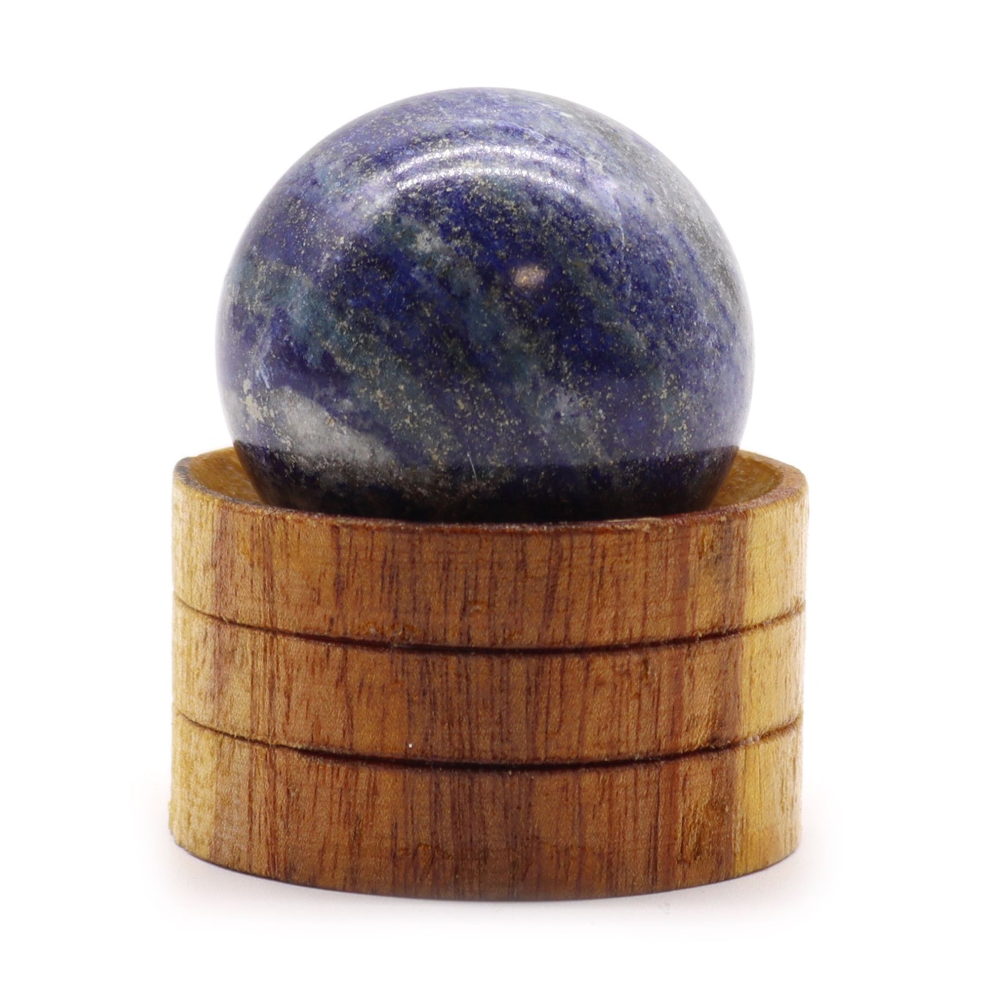 Deep blue 40mm Afghan lapis lazuli gemstone sphere with golden pyrite flecks resting on a small wooden stand.