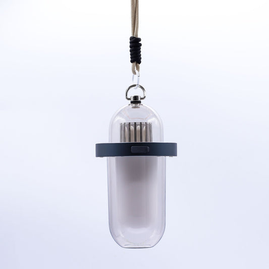 Sleek white portable outdoor lamp with a realistic flickering orange flame effect and minimalist cylindrical design.