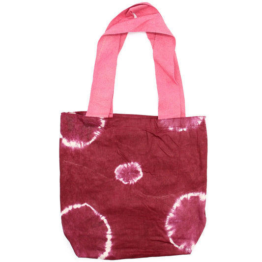 Spacious natural cotton tote bag featuring a unique maroon tie-dye ring pattern and vibrant pink fabric handles.