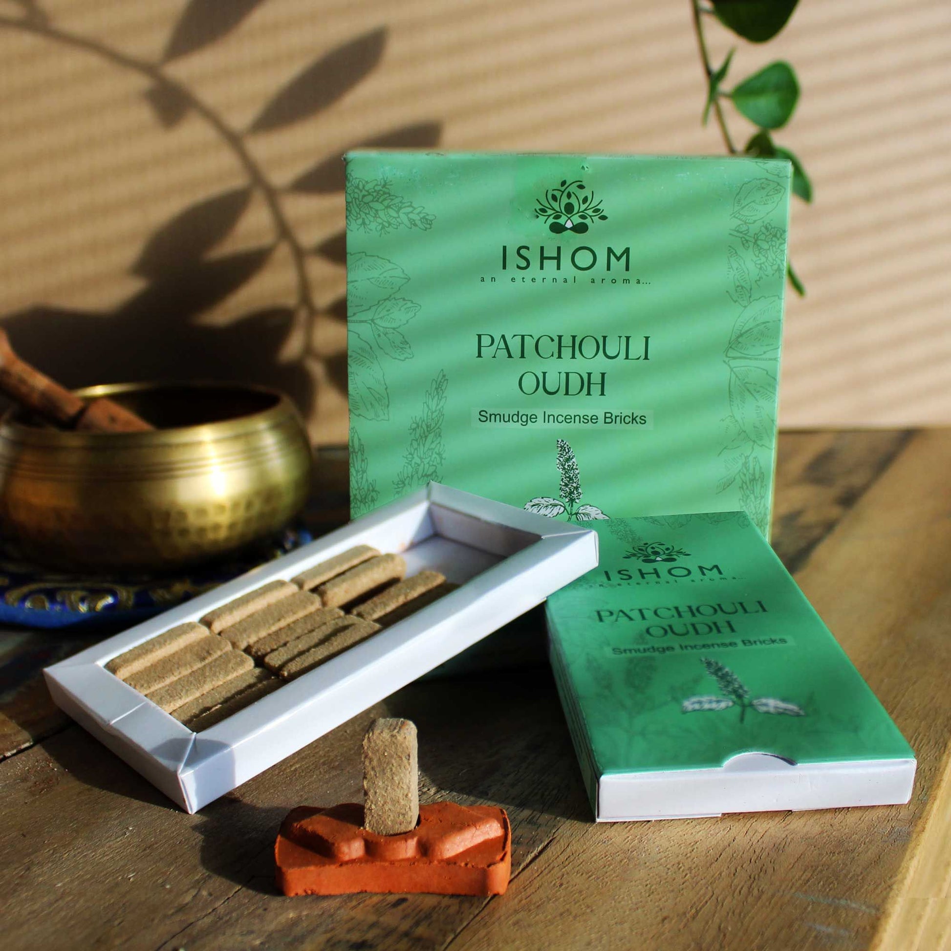 Natural square incense smudge bricks arranged next to a small round terracotta burner holder.