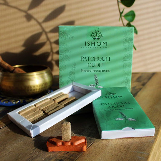 Natural square incense smudge bricks arranged next to a small round terracotta burner holder.