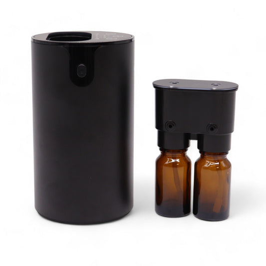 Sleek dual-nozzle waterless essential oil nebulizer in a compact cylindrical design with USB-C charging port.