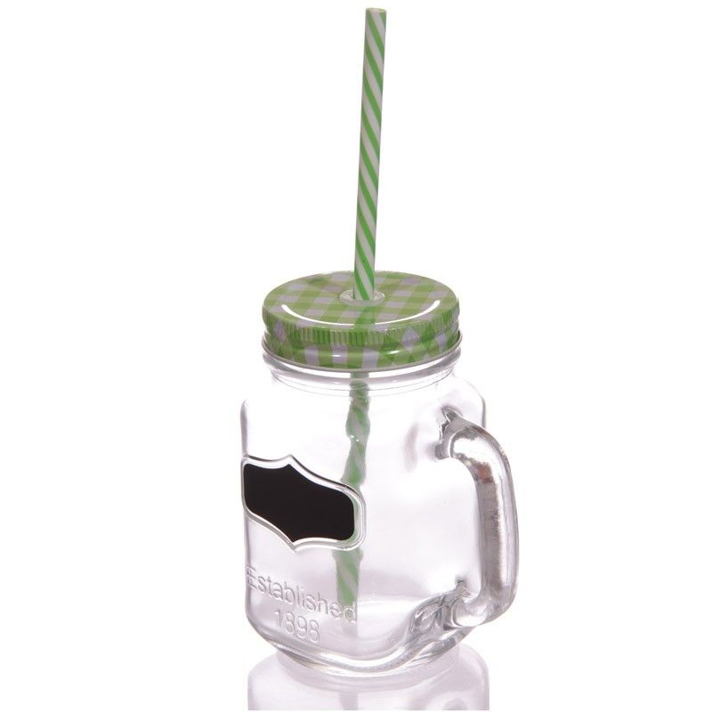 Retro green glass mason jar with a silver lid, reusable straw, and a black chalkboard label on the front.