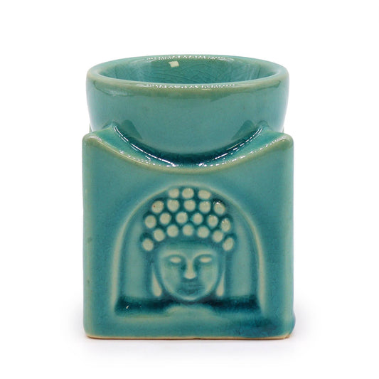 Square ceramic oil burner in soft turquoise featuring a peaceful Buddha face design on the side.