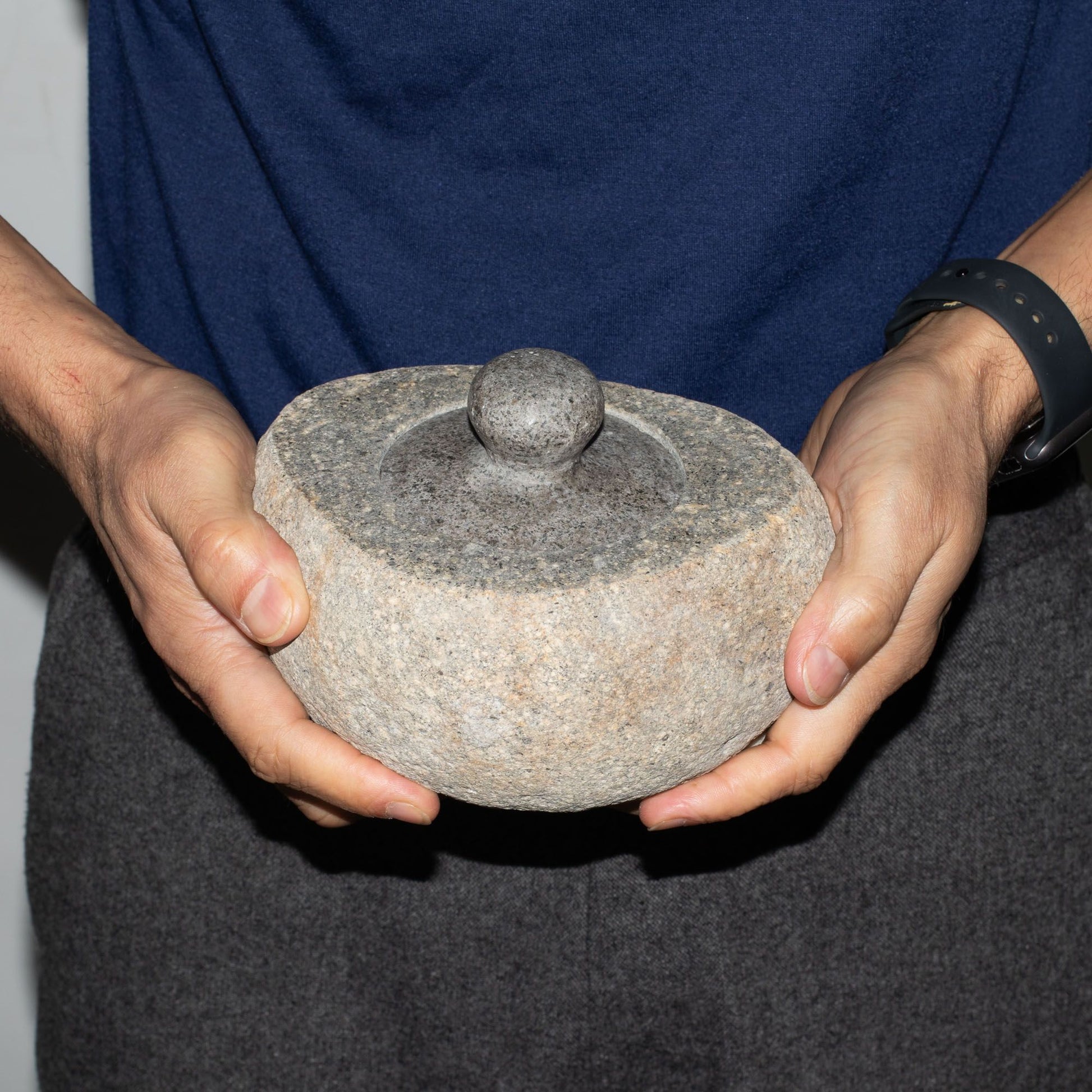 Large hand-carved natural riverstone pot with a smooth organic texture and earthy grey tones.