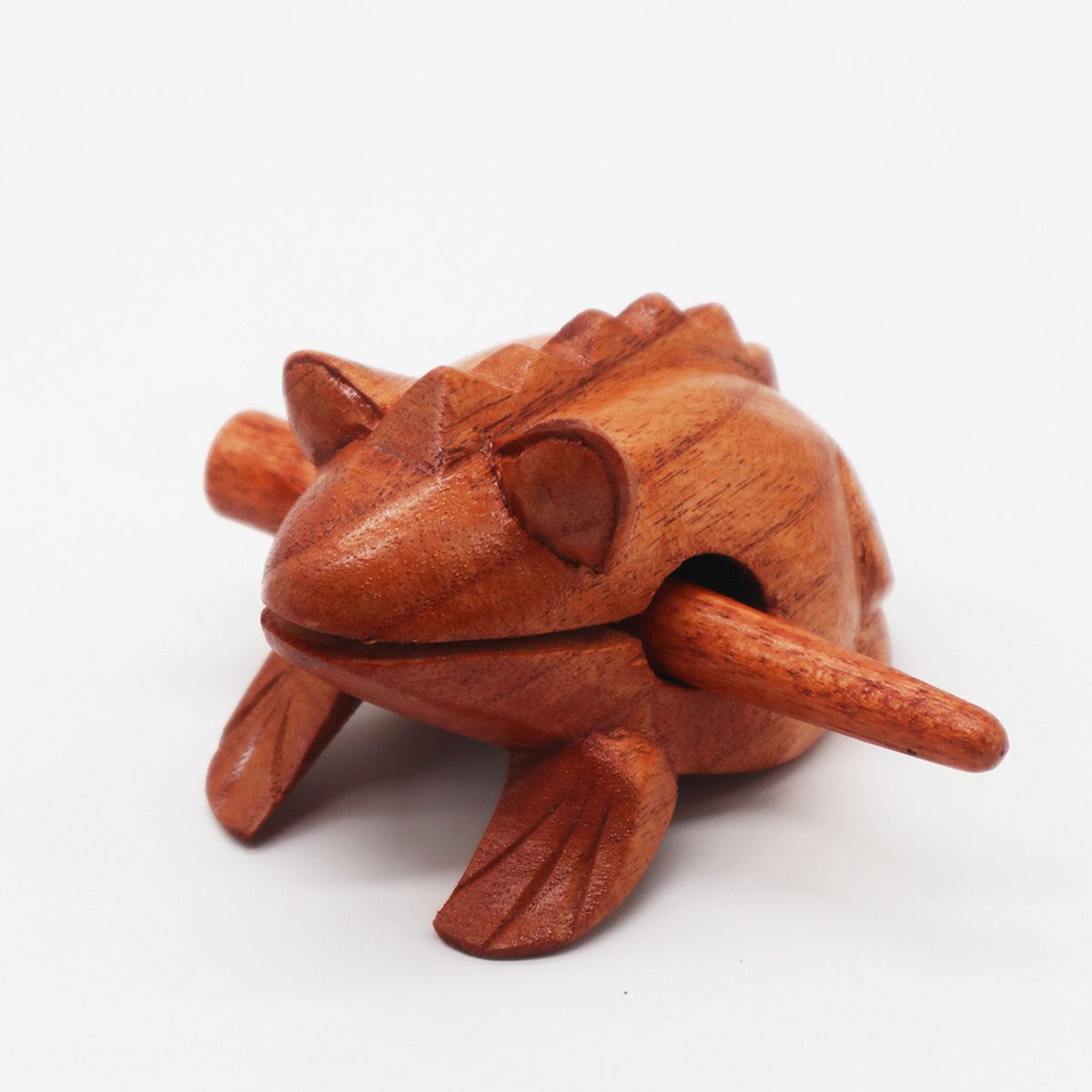 Handcrafted small wooden frog instrument with a wooden stick for creating a realistic croaking sound.