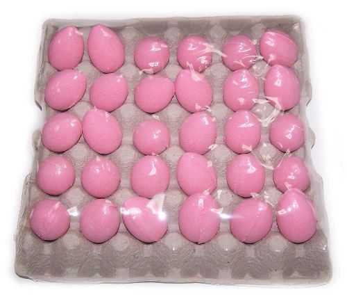 Tray of vibrant pink egg-shaped bath bombs with a sweet cherry fragrance for a fun and colourful bath time.