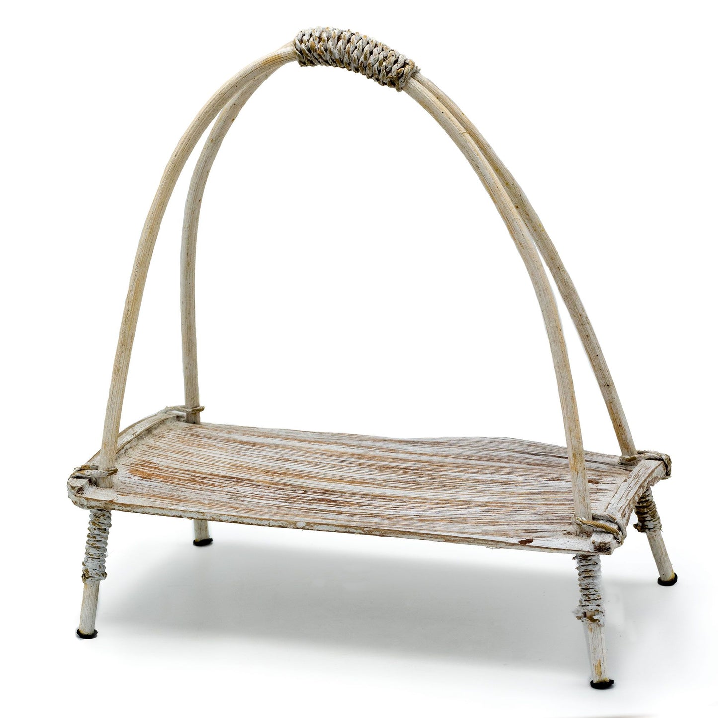 Handcrafted whitewashed tea stand made from a curved coconut leaf and rattan, displaying a natural and rustic texture.
