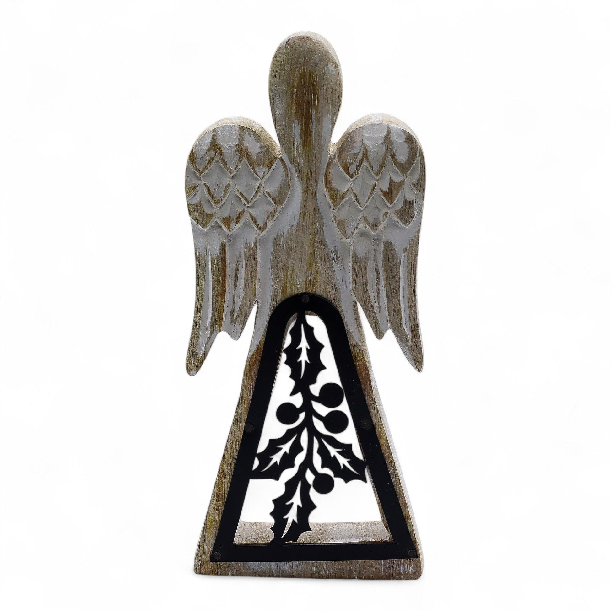 Hand-carved whitewashed mango wood angel figurine featuring a dark iron holly leaf cut-out detail on the skirt.