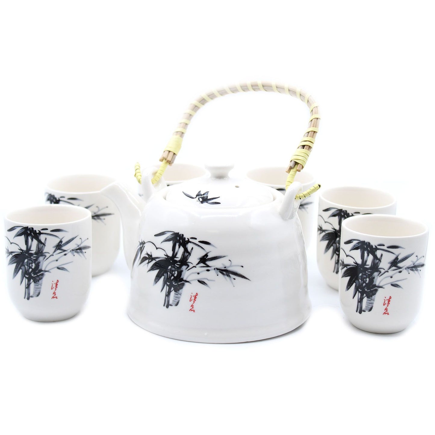Elegant white stone teapot with traditional oriental designs, a metal strainer, and six matching ceramic tea cups.