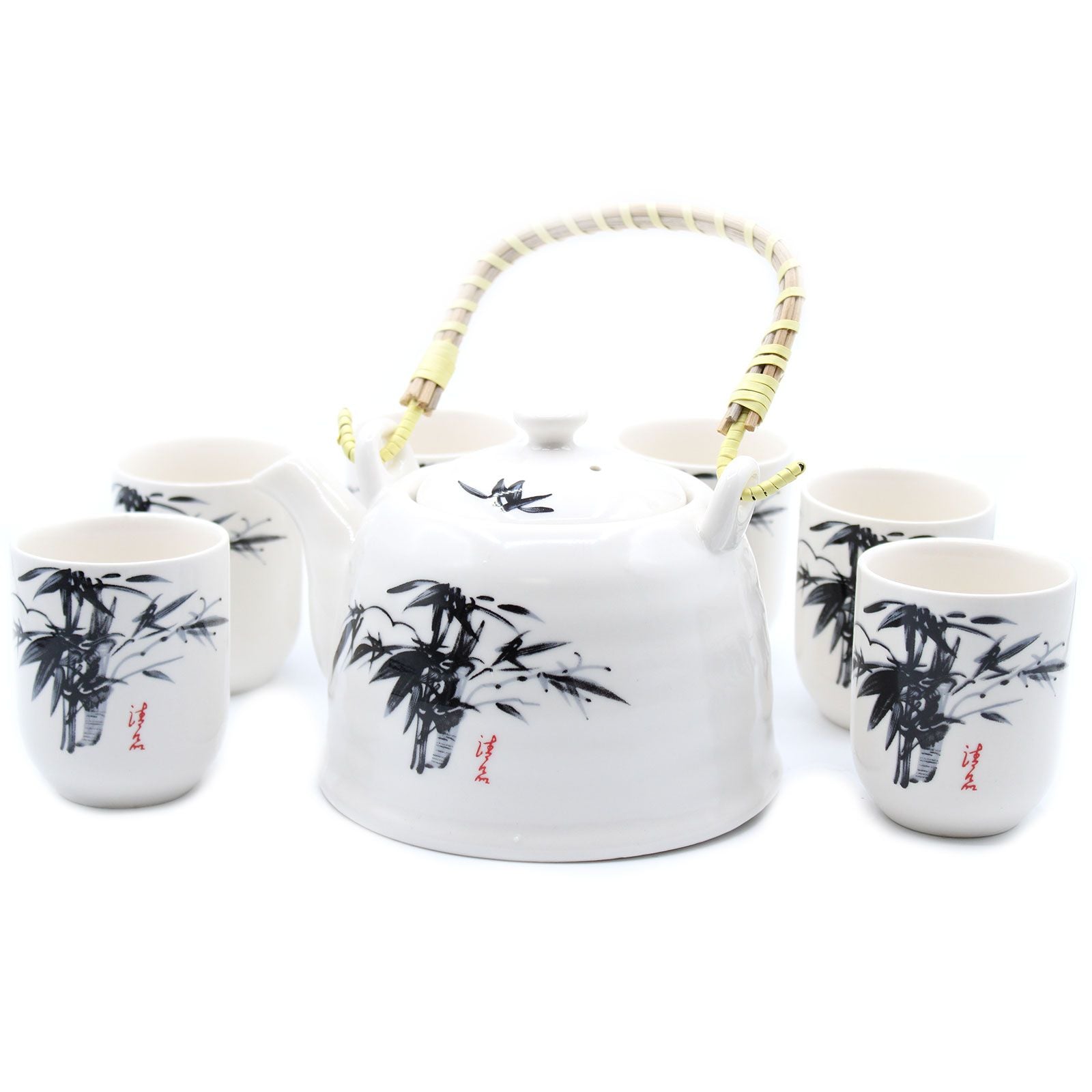Elegant white stone teapot with traditional oriental designs, a metal strainer, and six matching ceramic tea cups.
