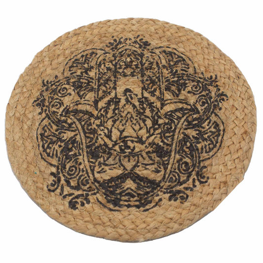 Round natural jute place mat with a black Hamsa hand print design on a rustic wooden surface.