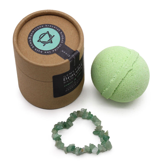 Large round artisanal bath bomb with a green aventurine gemstone bracelet tucked inside.