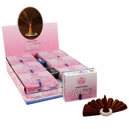 Handcrafted cylindrical rose scented dhoop incense cones on a rustic wooden surface.