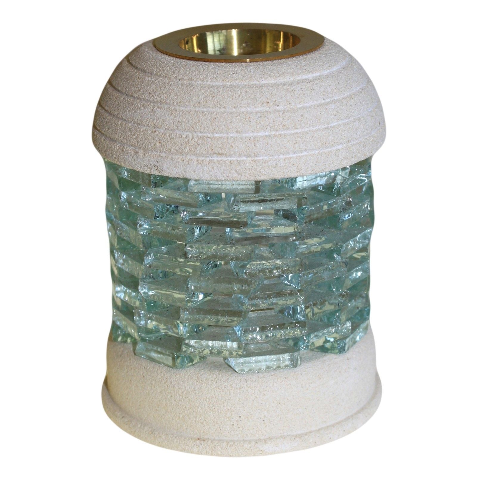 Hand-carved round sandstone oil burner with a glass brick inset and a recessed dish for essential oils on a natural base.