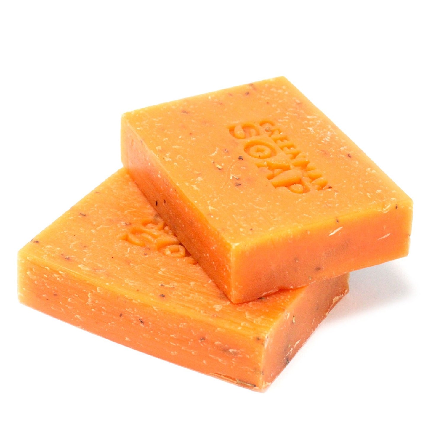 Handcrafted soap slice with visible dried rosemary leaves and a rich textured surface.