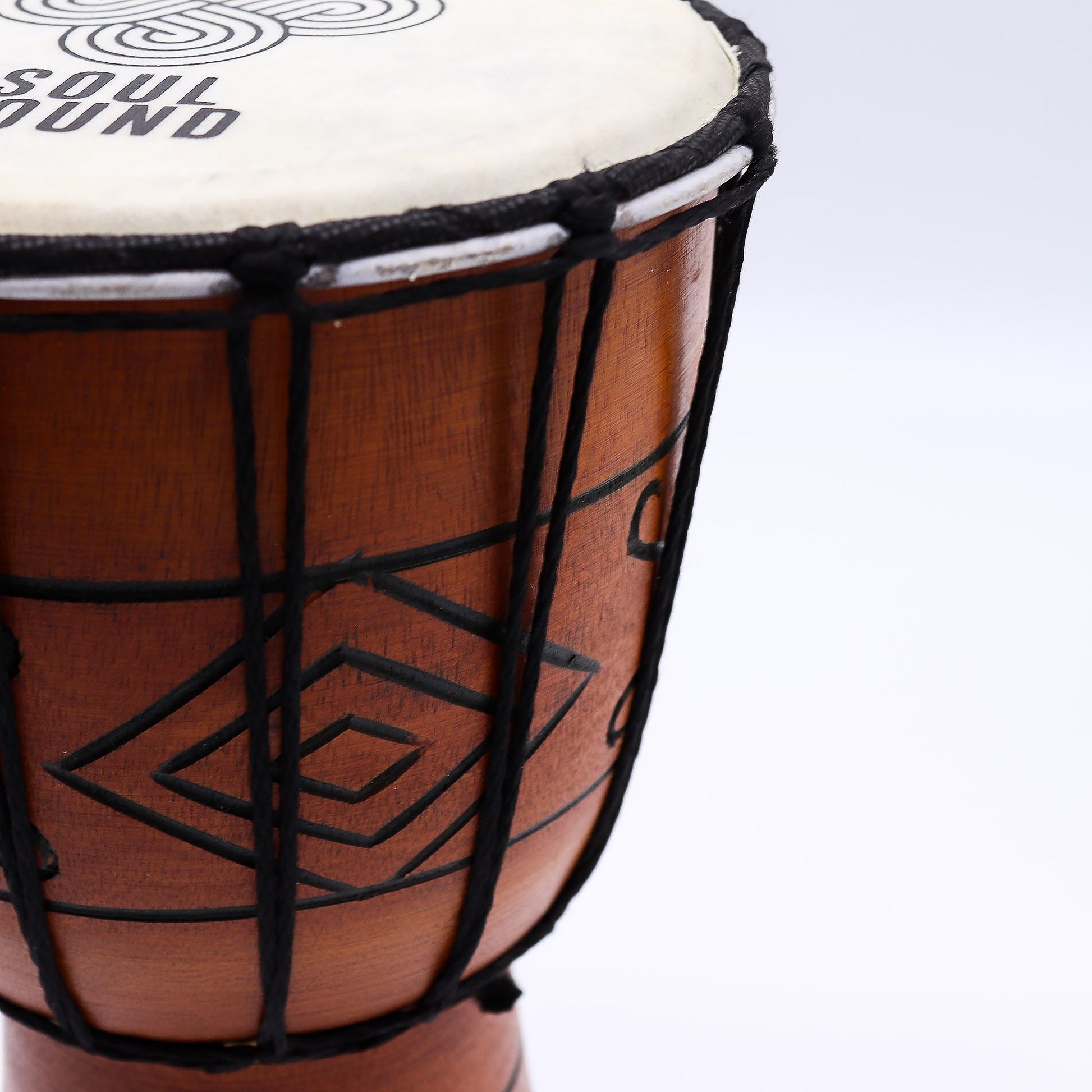Handcrafted small professional djembe drum featuring a natural skin head and traditional rope tuning.