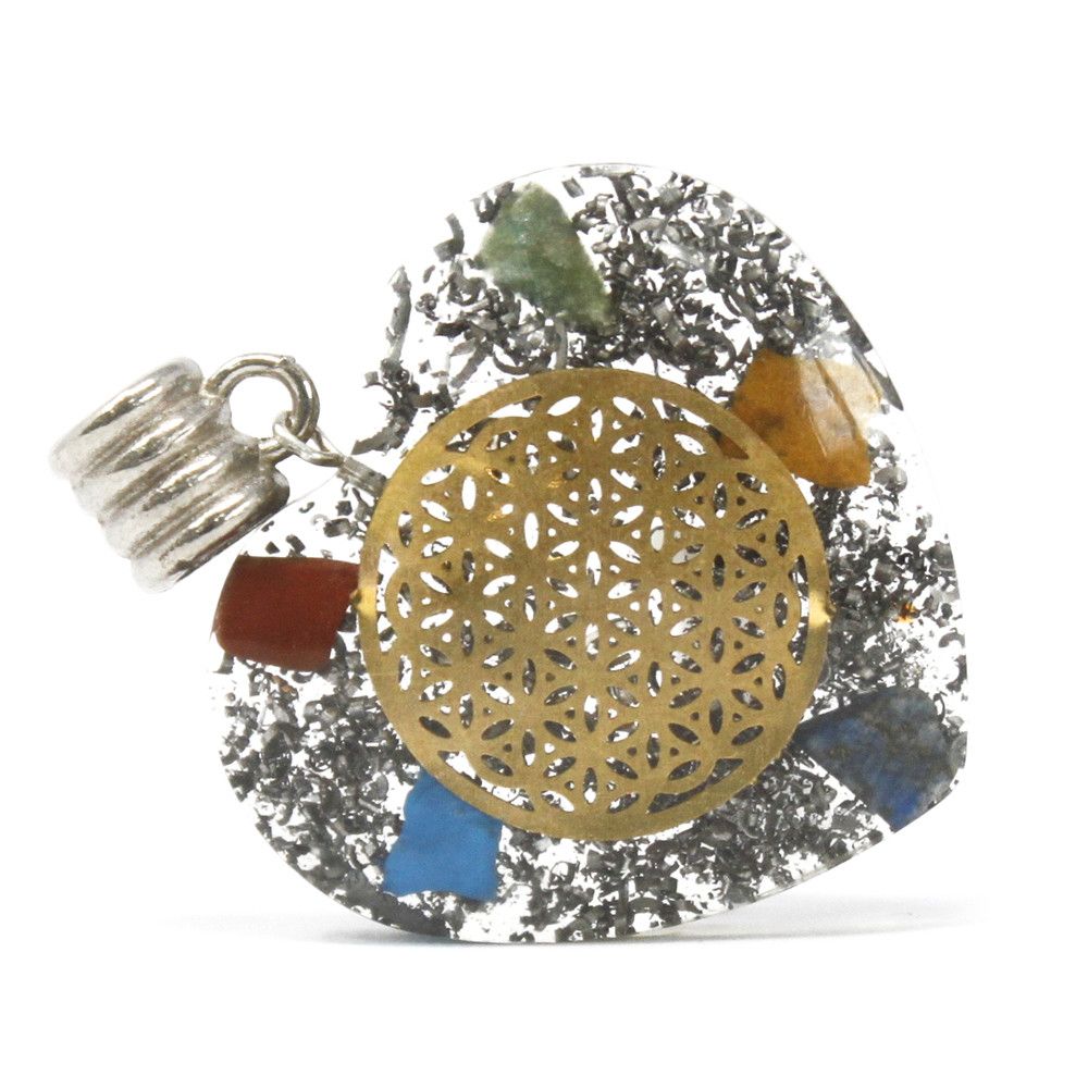 Heart shaped Orgonite pendant featuring layered chakra gemstones, copper spirals, and metal shavings in clear resin.