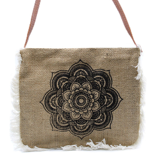 Soft washed jute bag featuring a white Mandela screen print, cotton fringe detail, and a dark leather-effect shoulder strap.