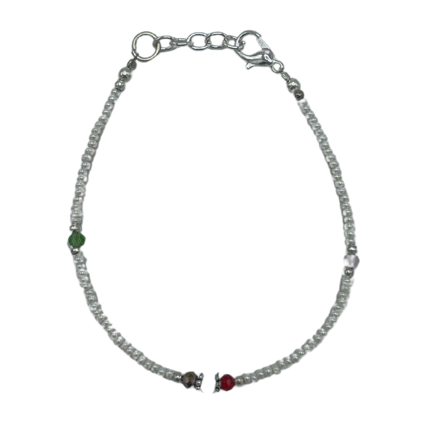 Handcrafted Nepalese bracelet featuring luminous white pearls and intricately faceted beads in a refined cultural design.